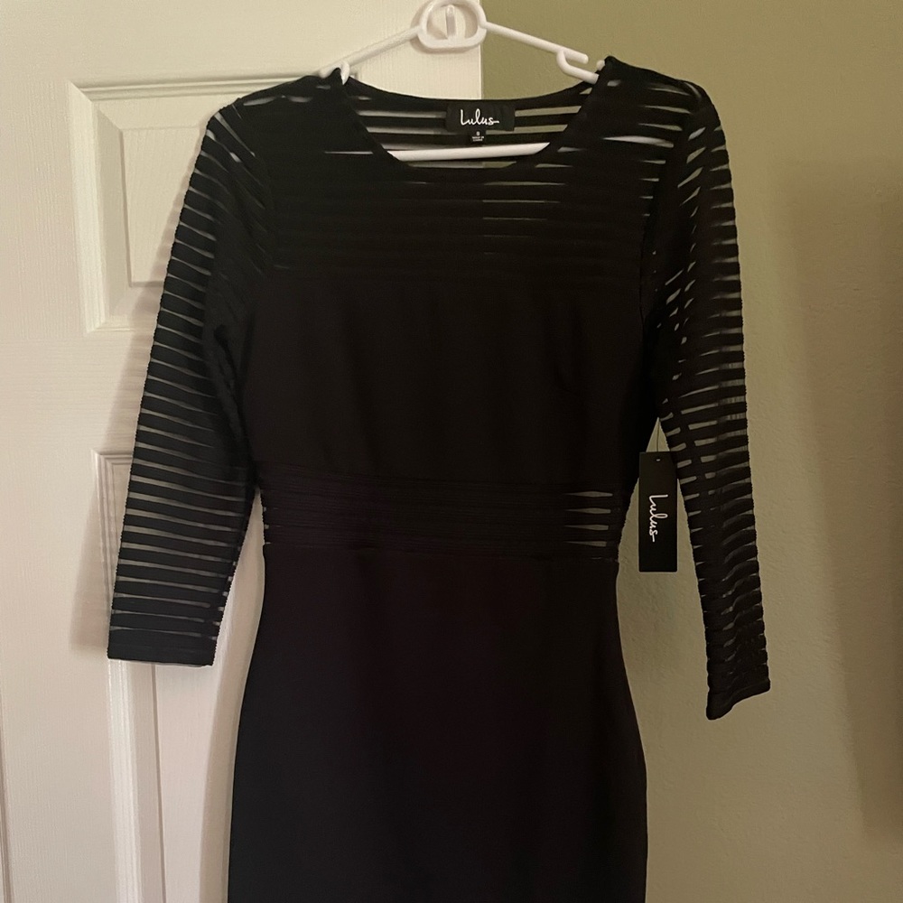 Black spandex dress with sheet middle and sheer 3/4 length sleeves.